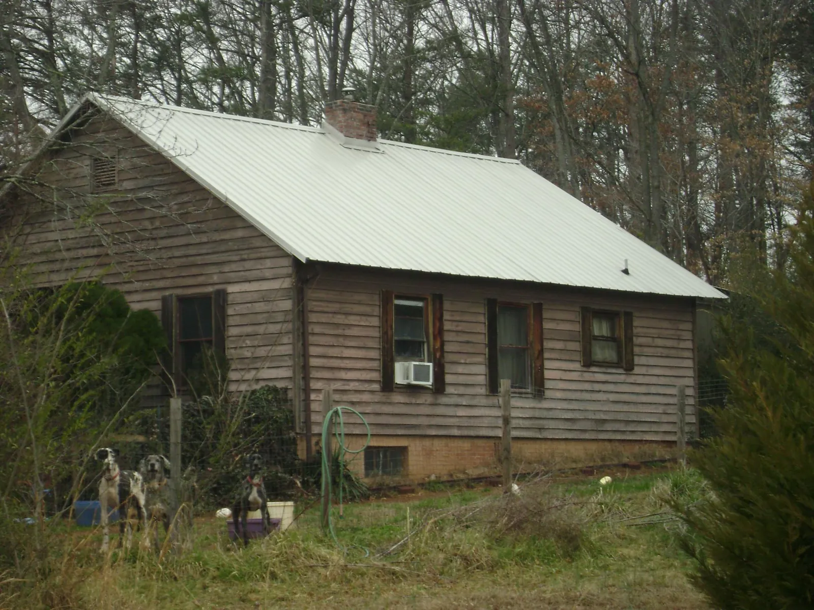 White metal roof on an old wood sided farmhouse, from a Metal Roof Installation job in Summitville